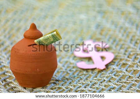 American Dollar symbol and clay piggy bank