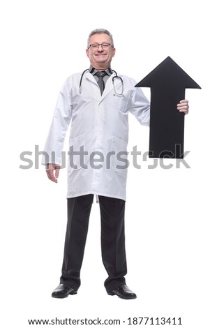 Mature doctor holding a black arrow pointing right