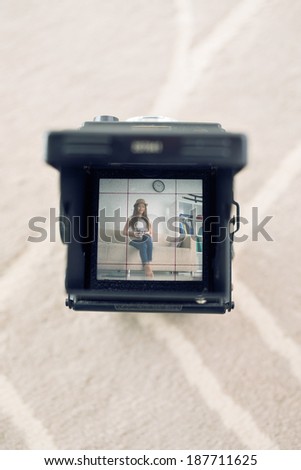 Camera with photo of a girl on the screen