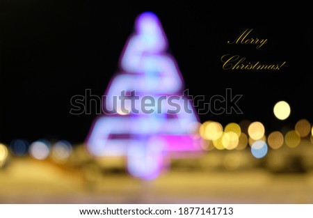 Blurred festive background made with christmas illuminations. Colorful purple Christmas tree and yellow Bokeh of the defocused, Christmas background pattern. Bokeh on night background. Copy space.