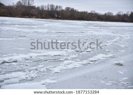 The frozen Bank of the river. White ice on the river. winter cold day
