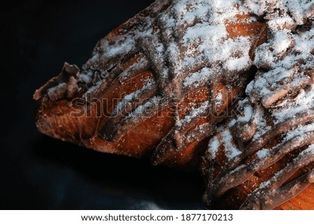 Cherry pie with chocolate icing sprinkled with powdered sugar close-up macro photography