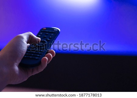 leisure at home. Watch TV. Remote control in hand close-up.