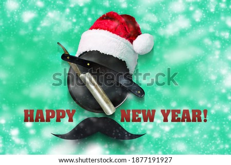Happy New Year. Razor, Santa Claus hat, on a green background. Snow effect. Happy New Year for the Barbershop. Festive background.