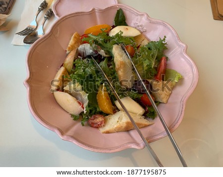 Fresh salad with various fruits and vegetables. It stimulates one's appetite with a sour taste. a picture of the concept taken from the front.