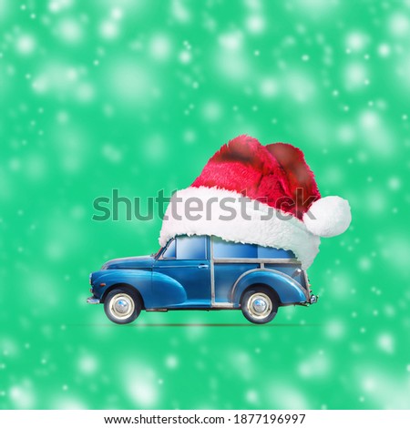 Retro car in Santa Claus Hat on a green background. Snow effect. Christmas background. Festive background.