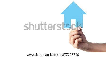 Hands holding  paper house, family home and protecting insurance concept