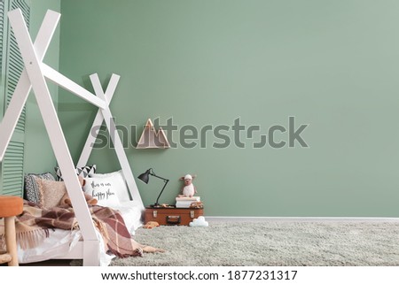 Interior of modern children's room with comfortable bed Royalty-Free Stock Photo #1877231317