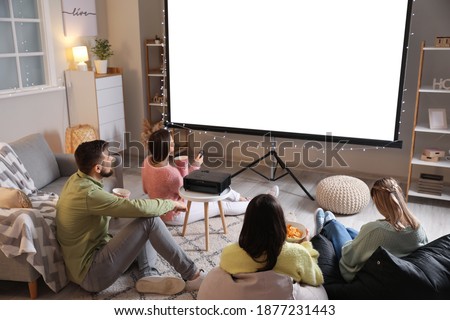 Young friends watching movie at home Royalty-Free Stock Photo #1877231443