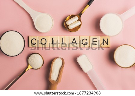 Collagen powder and pills spoons on pink background. Extra protein intake. Natural beauty and health supplement for skin, bones, joints and gut. Plant or fish based. Flatlay, top view. Copy space. Royalty-Free Stock Photo #1877234908
