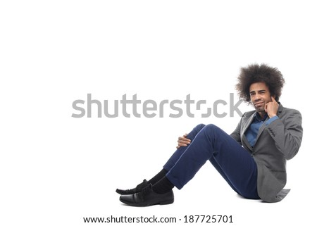 Man with afro sitting on the ground