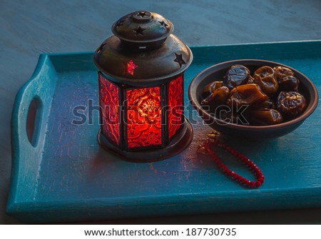 Ramadan lamp and dates on a wooden tray Royalty-Free Stock Photo #187730735