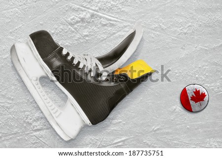 Hockey skates and the puck with the image of the Canadian flag 