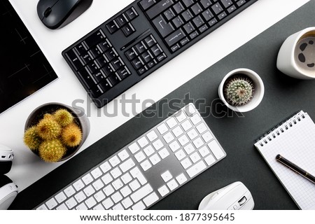 Cup of coffee with office tools on black and white background, office flat lay
