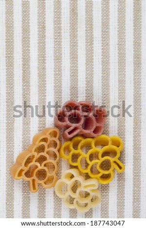 Multicolored pasta on striped napkin 