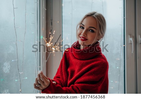 Beautiful young woman having fun with a sparkler. girl having fun and laughing holding burning sparklers in her hand.   