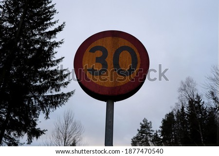 Swedish 30 km per h speed limit. Isolated. Very dirty sign. For traffic. In Stockholm, Sweden.