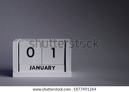 January 1st. Day 1 of month, calendar on grey background. Winter time. New year at work concept. Copy space