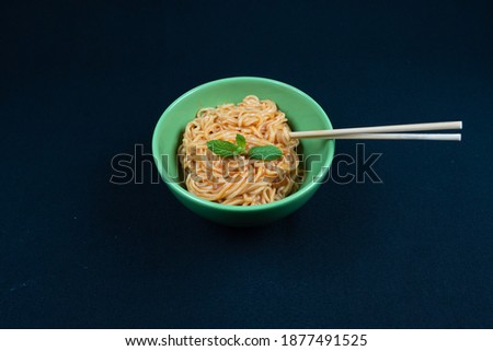 Sauced Noodles or Hakka or Chow Mein in black bowl at dark background.