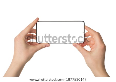 Shooting on smart phone concept. Close up photo pov of female hands holding smart gadget device in horizontal position taking making picture isolated white color background Royalty-Free Stock Photo #1877530147