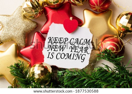 top view of a set of different Christmas toys for decoration with a greeting card with an inscription KEEP CALM NEW YEAR IS COMING . holidays
