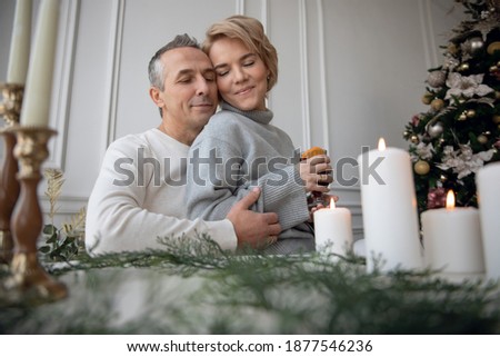 adult man and woman drink mulled wine at the festive table