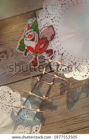 Happy Santa Claus with gifts and Christmas tree. Festive decorations for the New Year. Decorative drifts.  Ideas To Capture the Festive Mood of The Winter Season. Happiness. Play of light and shadow