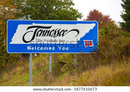 The state of Tennessee welcomes you to The Volunteer State with a sign on the highway