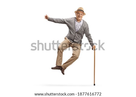 Full length portrait of a happy elderly man jumping isolated on white background Royalty-Free Stock Photo #1877616772