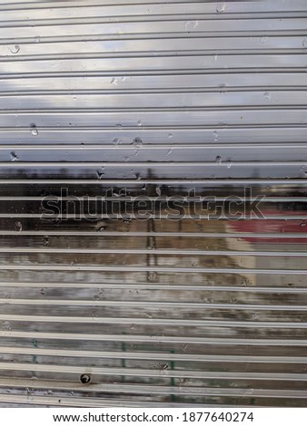 transparent plastic panel with stripes on the background of the yard