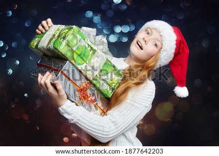 teenage girl in a Santa hat holds gifts in her hands