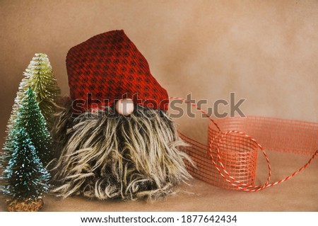 New year decoration, a gnome and pine trees, brown paper