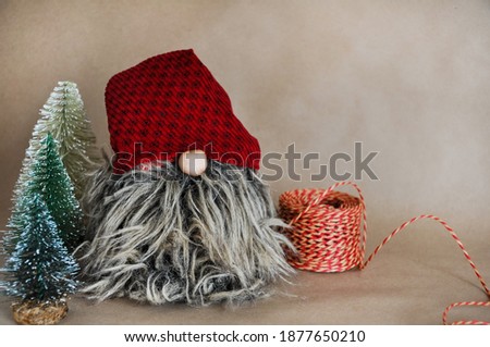 New year decoration, a gnome and pine trees, brown paper