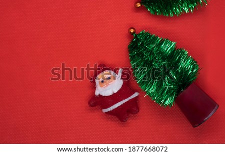 Top view Christmas tree with Santa Claus on red studio background. copy space