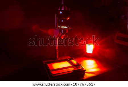 Analog photo printing. Photolaboratory. Red light