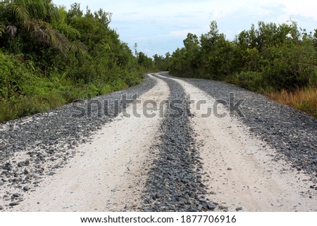 Rocky road across savanna that is still under construction 