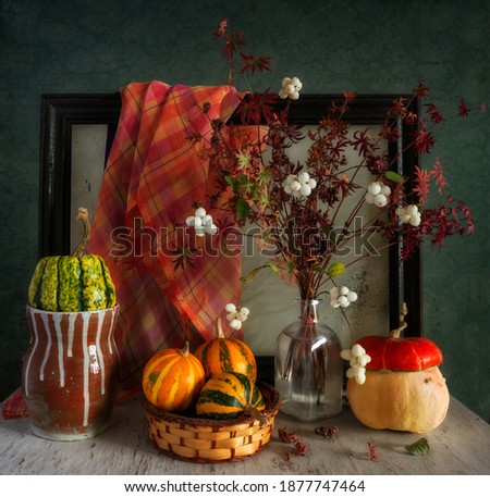 Still life with pumpkins, an autumn bouquet and a wooden frame from the picture. Vintage.