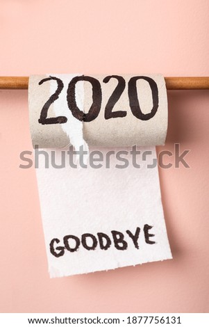Toilet paper roll with text Goodbye 2020 on pink background Royalty-Free Stock Photo #1877756131