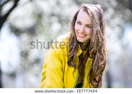 Pretty spring woman in the garden happy smiling and looking to the side. copy space