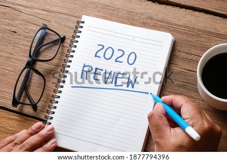 2020 Review; last year review in life; flat lay business concept. Writing and preparing for new year 2021 resolutions Royalty-Free Stock Photo #1877794396