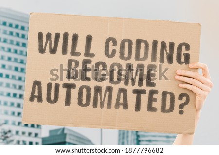 The question " Will coding become automated? " on a banner in men's hand with blurred background. Technology. Artificial intelligence. AI. Programming. Code. Software Development. Developers