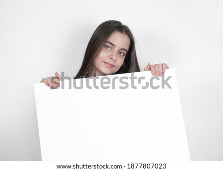 A portrait of a young girl draws attention away from a blank board.