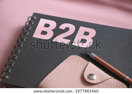 Text B2B on copybook, pink leather wallet and pen. Small Business concept