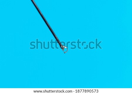 Macro photo of a medical needle from a syringe on a blue background. The concept of vaccination in health care