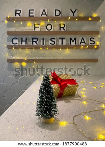Focus on small Christmas tree on the white table decorated in the cafe