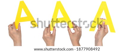 closeup hands holding paper letter A isolated on white