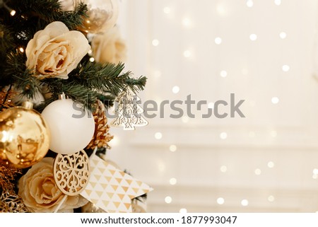 Gold Christmas background of de-focused lights with decorated tree, new year