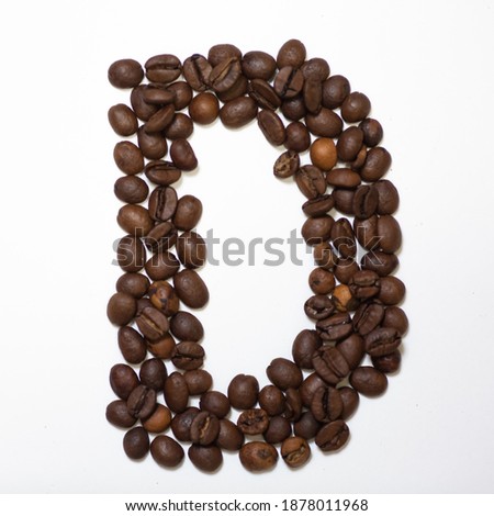Symbol D, the letter of an aphovite made of coffee. Coffee background, letter D