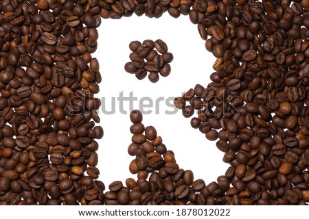 Symbol R, the letter of an aphovite made of coffee. Coffee background, letter R