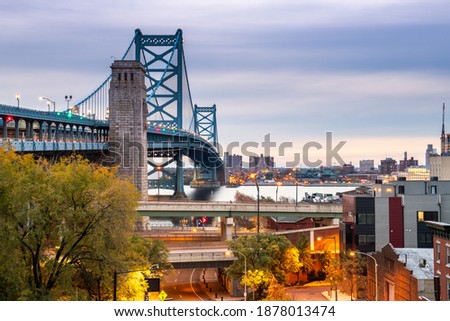 Philadelphia, Pennsylvania, USA at Benjamin Franklin Bridge spanning the Delaware River towards Camden, New Jersey.